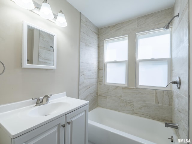 bathroom with vanity and tiled shower / bath