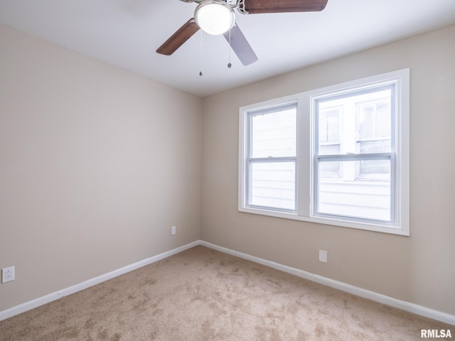 carpeted empty room featuring ceiling fan