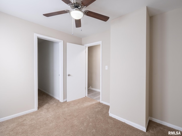 unfurnished bedroom with a closet, ceiling fan, and light colored carpet