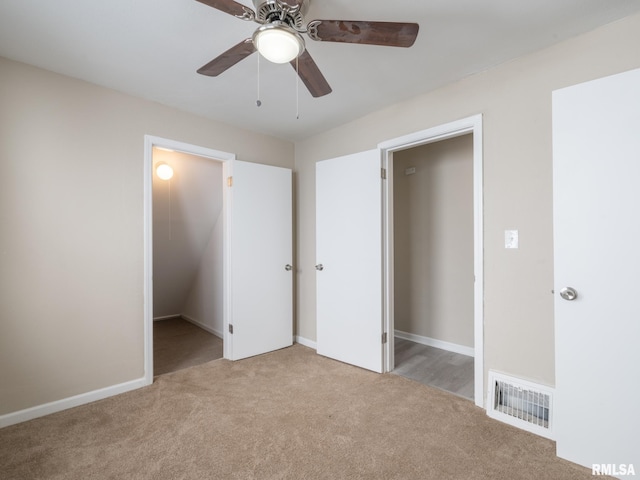 unfurnished bedroom with ceiling fan, a closet, and light carpet