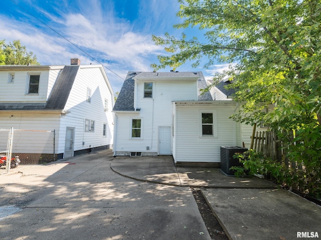 back of house featuring cooling unit