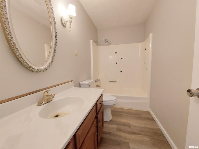 full bathroom with wood-type flooring, vanity, bathing tub / shower combination, and toilet