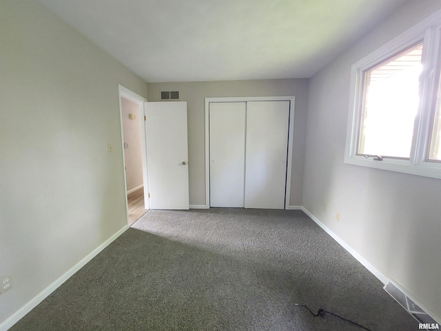 unfurnished bedroom featuring a closet and carpet