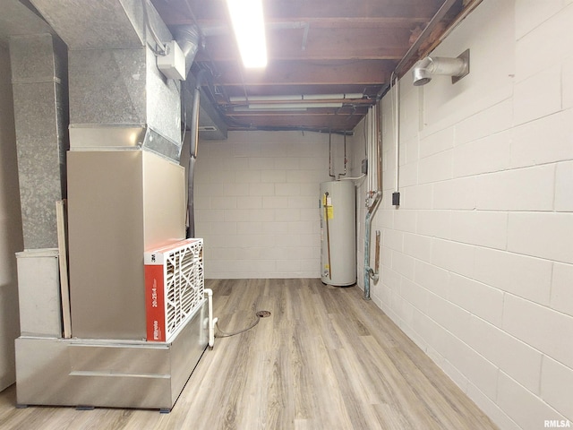 basement featuring light hardwood / wood-style floors and gas water heater