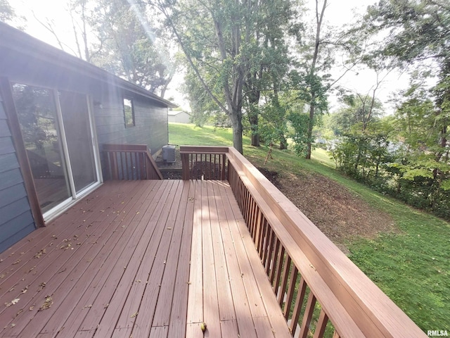 wooden deck featuring a lawn