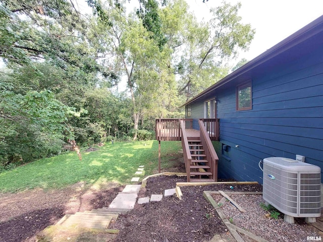 view of yard with a deck and central AC