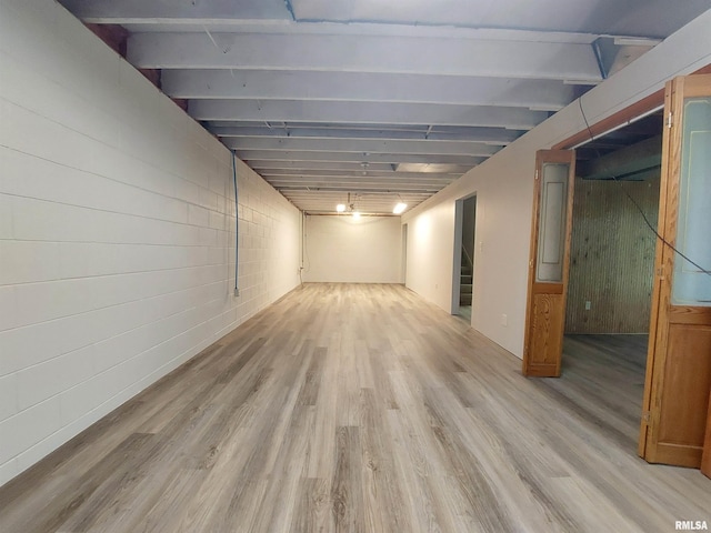 basement with light hardwood / wood-style flooring