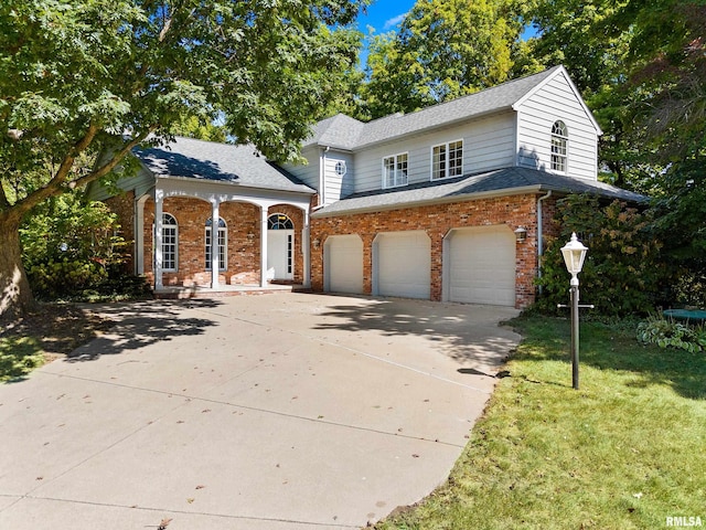 view of front of property with a front lawn and a garage