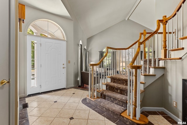 tiled entrance foyer with vaulted ceiling