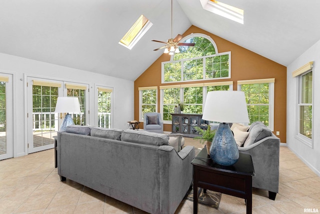 tiled living room with ceiling fan, a skylight, and a healthy amount of sunlight