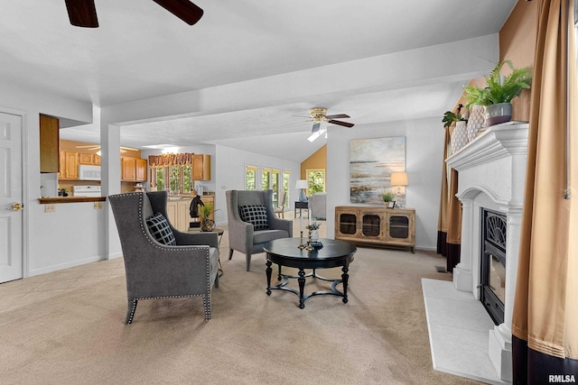 carpeted living room with ceiling fan and vaulted ceiling