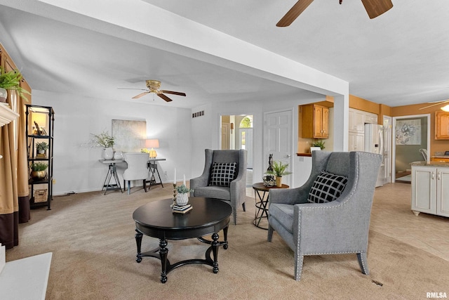 living room with ceiling fan and light carpet