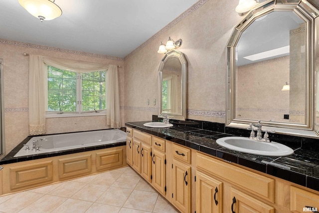 bathroom featuring vanity, a bathing tub, and tile patterned flooring