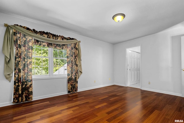 unfurnished room with dark hardwood / wood-style floors