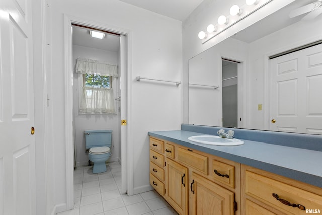 bathroom with vanity, toilet, ceiling fan, and tile patterned floors