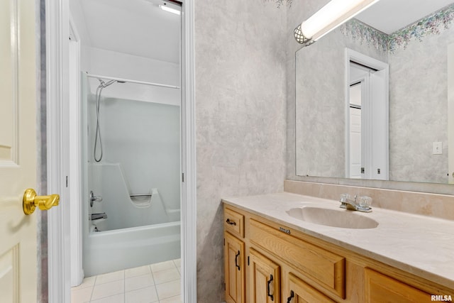 bathroom featuring tile patterned flooring, bathing tub / shower combination, and vanity