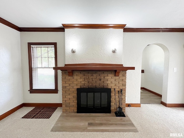 unfurnished living room with a brick fireplace, light colored carpet, and crown molding