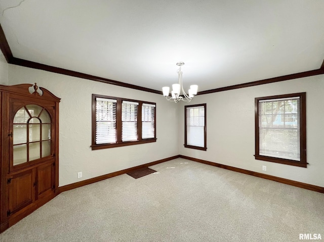 empty room with an inviting chandelier, light colored carpet, and a wealth of natural light