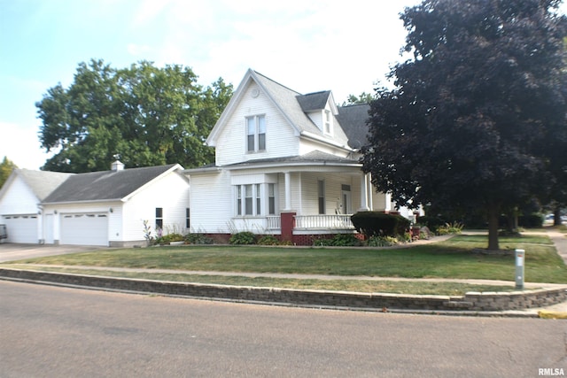 farmhouse inspired home featuring a garage, a front lawn, and covered porch