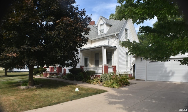 view of front of house with a garage, a front lawn, and a porch