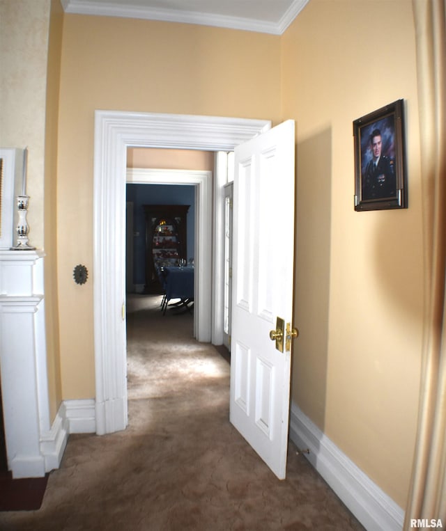 corridor featuring dark carpet and ornamental molding