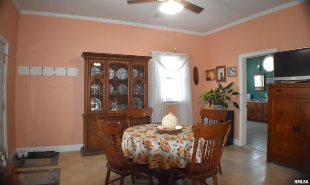 dining room featuring ceiling fan and crown molding