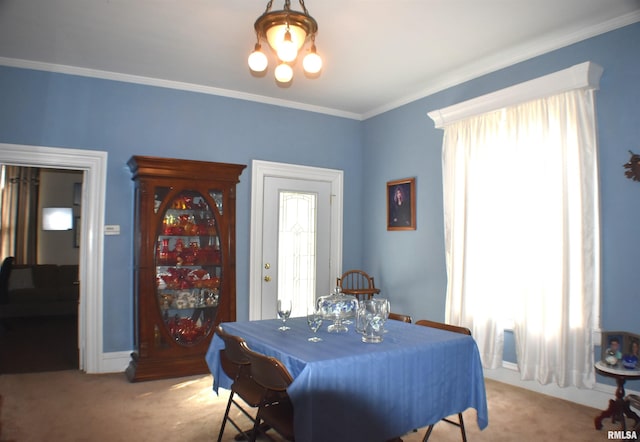 dining space with light colored carpet and crown molding