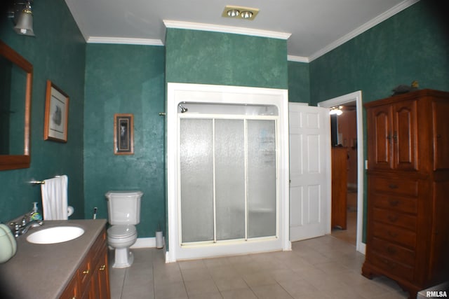 bathroom with tile patterned flooring, a shower with door, crown molding, vanity, and toilet