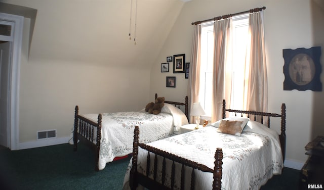 bedroom featuring vaulted ceiling and dark colored carpet