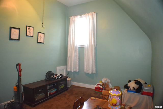 rec room with dark carpet and vaulted ceiling