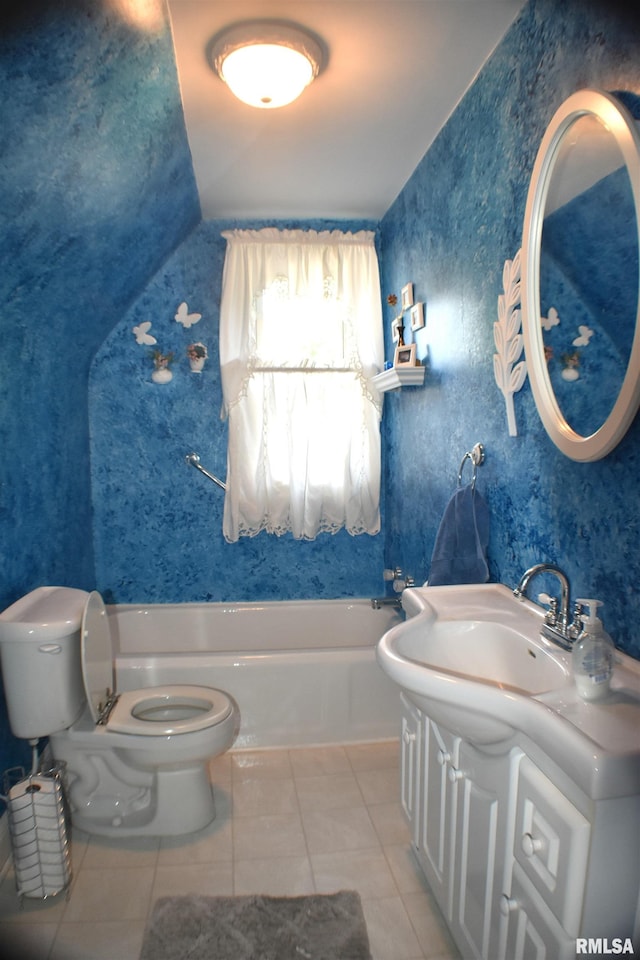 bathroom featuring vanity, tile patterned flooring, toilet, and a washtub