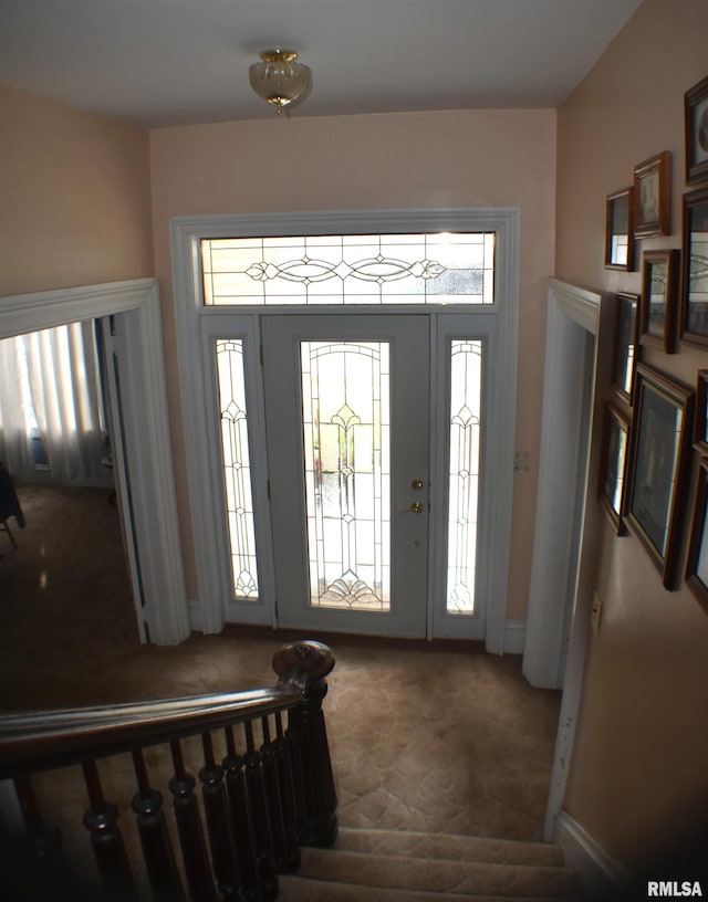 carpeted entryway featuring plenty of natural light