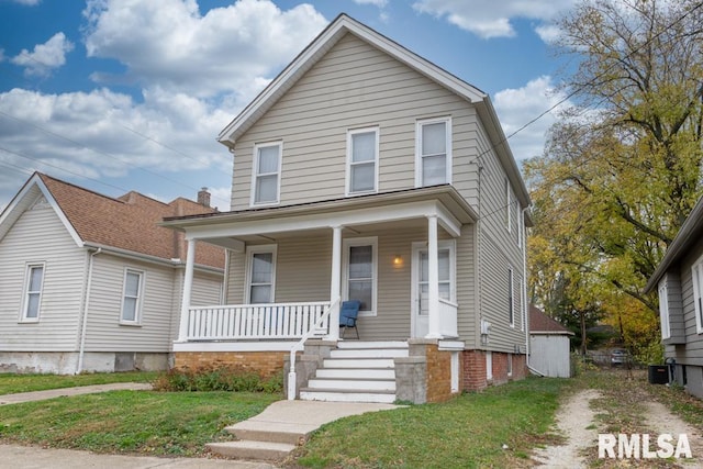 view of front facade with cooling unit, covered porch, and a front lawn