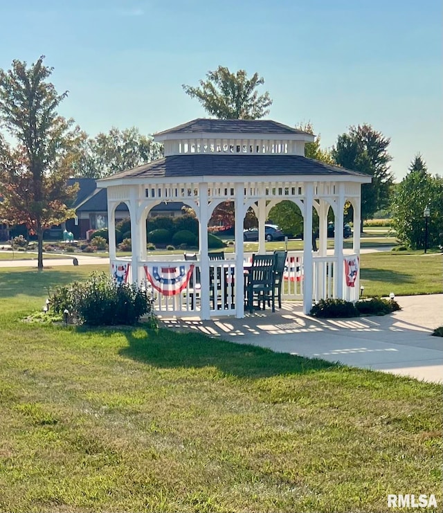 surrounding community with a lawn and a gazebo