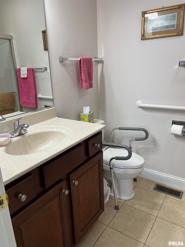 bathroom featuring tile patterned flooring, vanity, and toilet