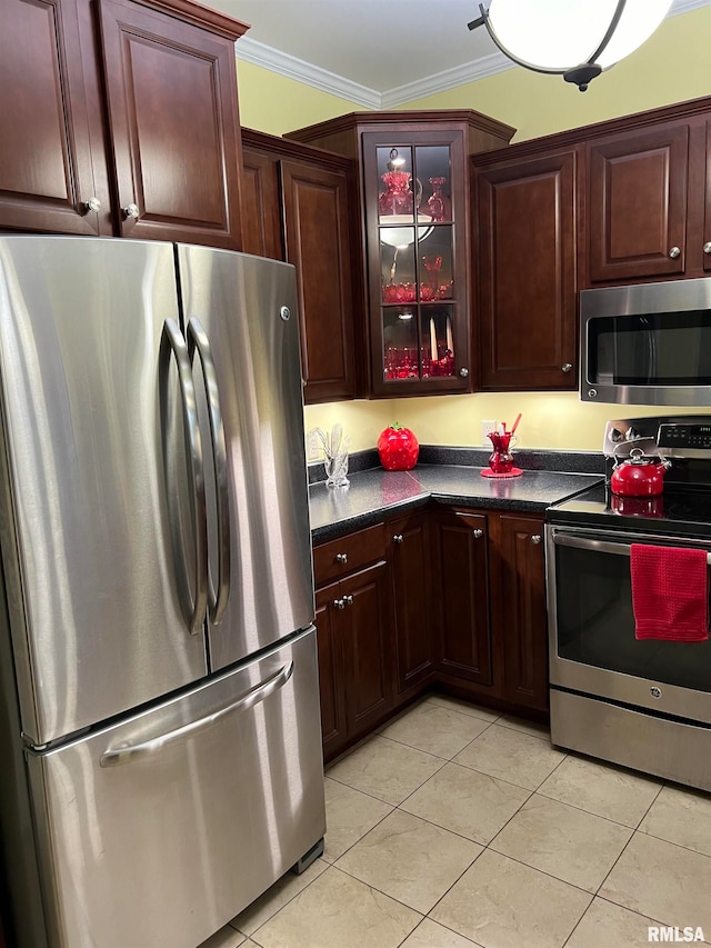 kitchen featuring light tile patterned floors, appliances with stainless steel finishes, and ornamental molding