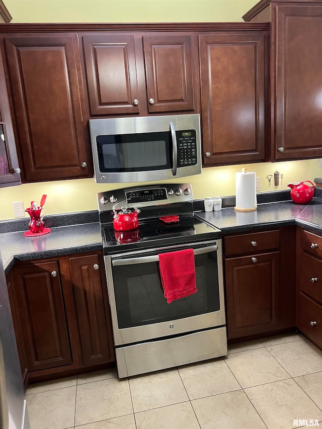 kitchen featuring appliances with stainless steel finishes and light tile patterned flooring