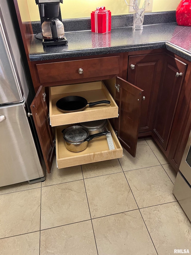 kitchen featuring stainless steel fridge and tile patterned floors