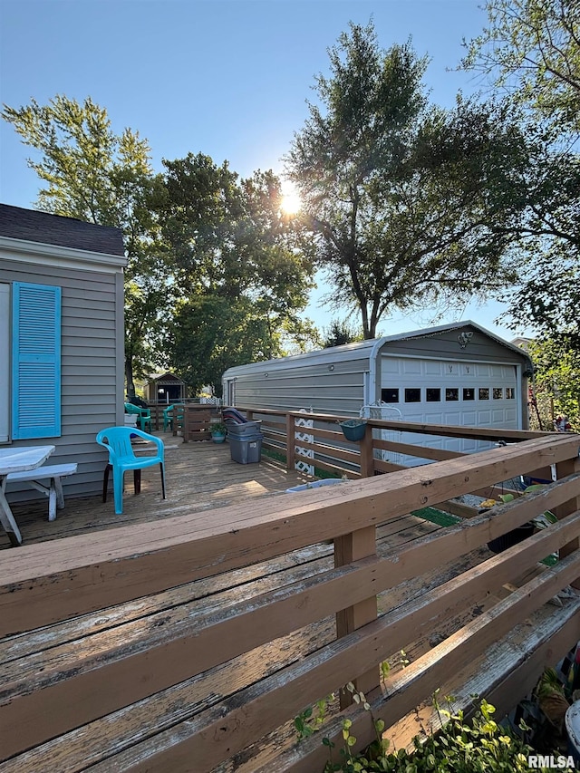 deck featuring an outdoor structure and a garage