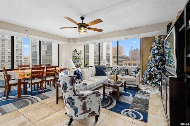 tiled living room featuring ceiling fan and a textured ceiling