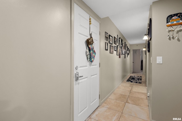 corridor featuring light tile patterned floors