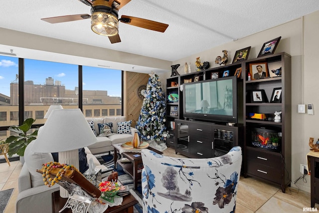 125 SW Jefferson St Unit W-5C, Peoria, IL 61602 - living room featuring light tile patterned floors, a ceiling fan, and a textured ceiling
