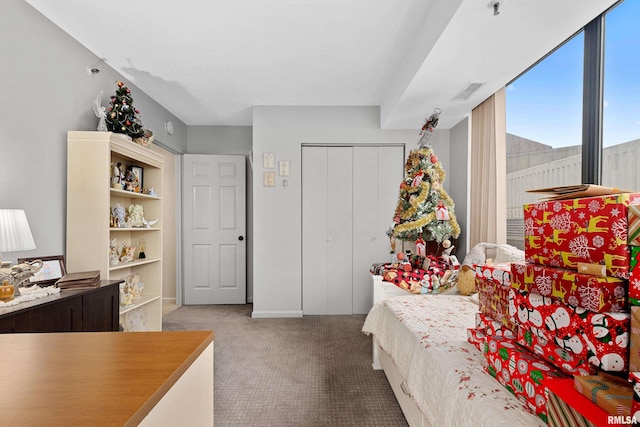 bedroom featuring light colored carpet and a closet