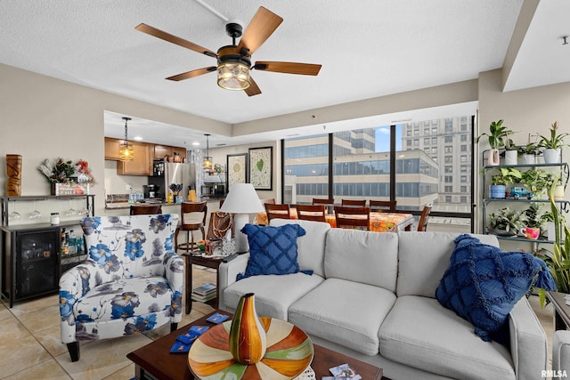 tiled living room featuring a textured ceiling and ceiling fan