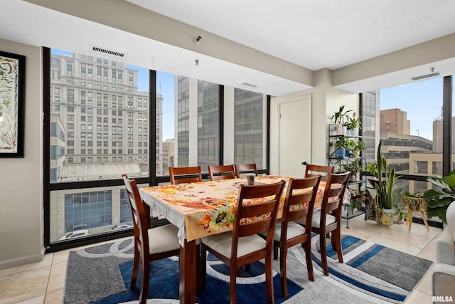 dining space featuring floor to ceiling windows, light tile patterned floors, and a wealth of natural light