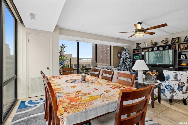 dining space featuring a textured ceiling and ceiling fan