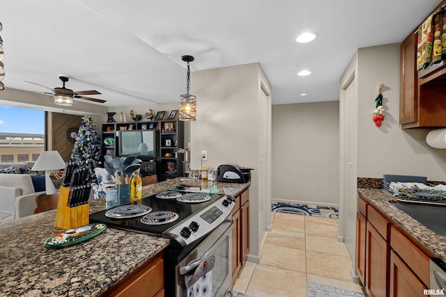 125 SW Jefferson St Unit W-5C, Peoria, IL 61602 - kitchen with stainless steel electric stove, brown cabinets, open floor plan, ceiling fan, and dark stone countertops