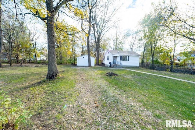 view of yard featuring an outbuilding and a garage