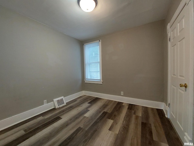 empty room featuring dark hardwood / wood-style flooring