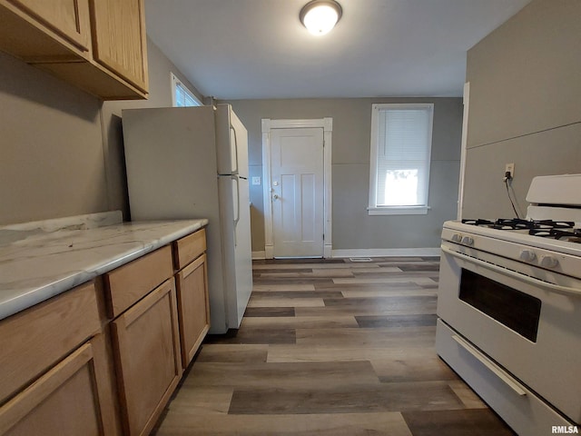 kitchen featuring light wood-type flooring, white appliances, and light brown cabinets